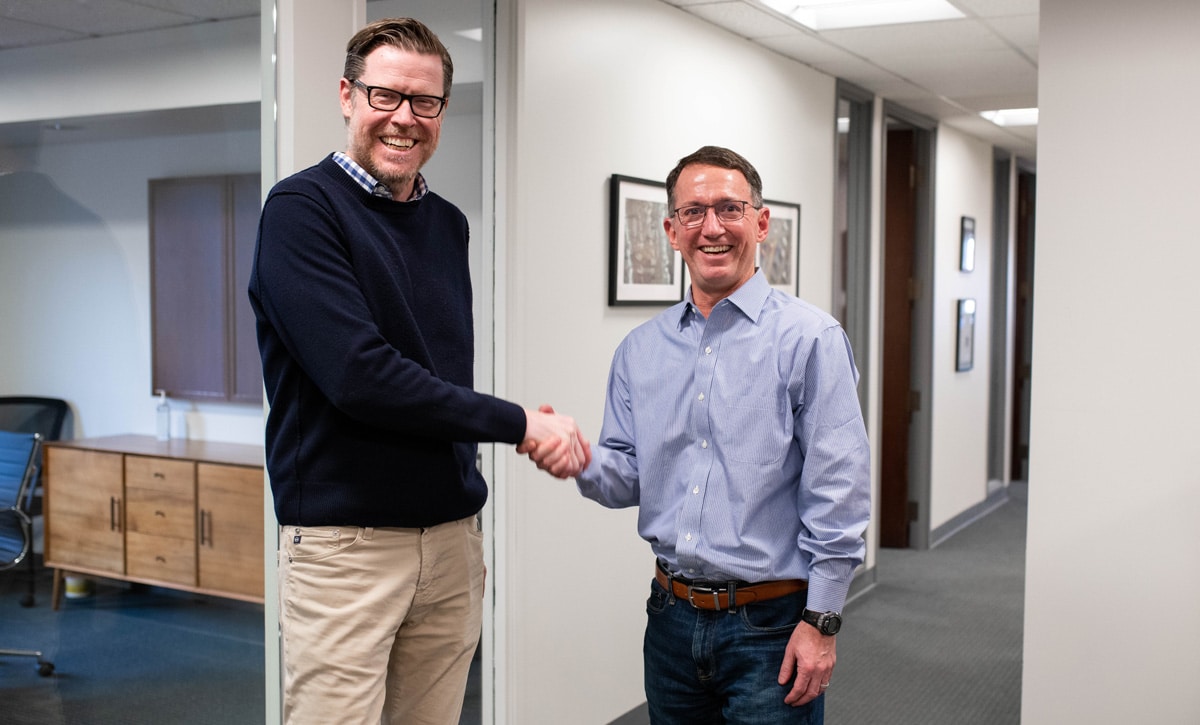 Elsmere Education Founder and Chairman of the Board, Justin McMorrow shakes hands with CEO, Dan Janick.
